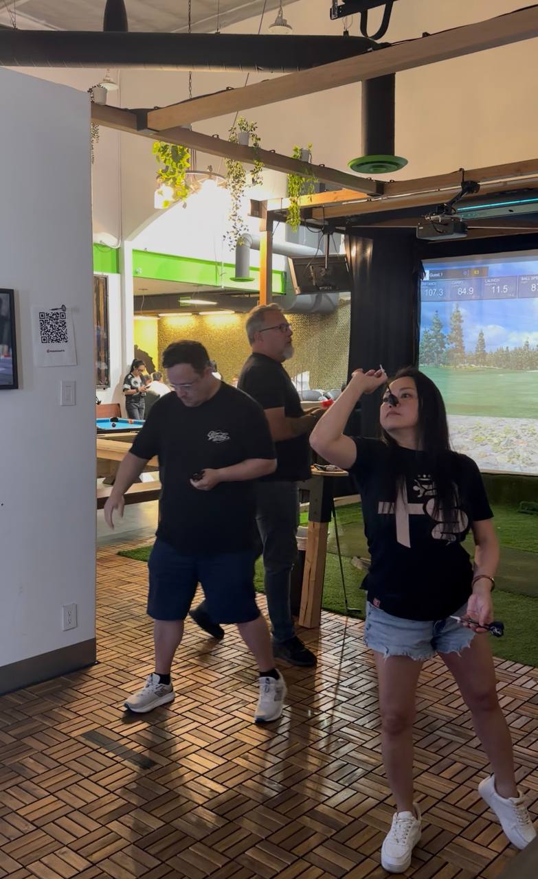 Capitalist Club members competing at darts